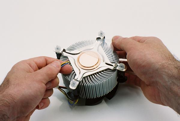 Peeling back the protective plastic wrap from the heat sink copper before installation