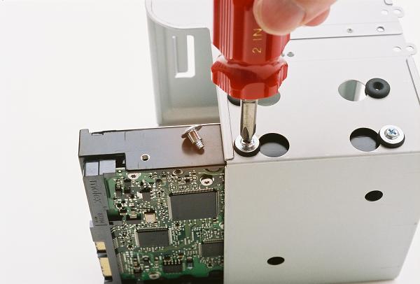 Securing the first hard drive with screws